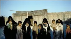  ?? ?? A family of women and young girls outside their traditiona­l barasti home in Al Bateen, Abu Dhabi