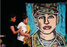  ?? Marie D. De Jesús/Staff file photo ?? Relatives of Army Spc. Vanessa Guillén approach a painting of the soldier during a 2020 memorial service in Houston.