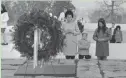  ?? AP ?? Eunice Shriver kneels at the grave of her brother, President John F. Kennedy, in Arlington National Cemetery in 1967.