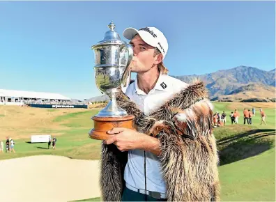  ?? GETTY IMAGES ?? New Zealand Open winner Zach Murray with the Brodie Breeze Challenge Cup and what was described and what was described on Sunday as a korowai.