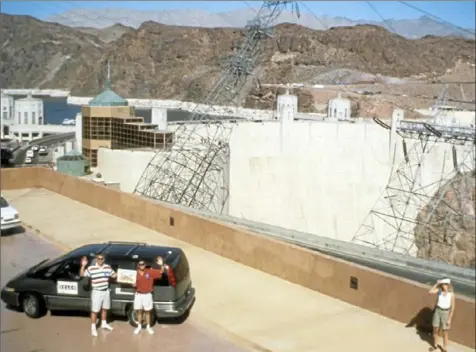  ?? Courtesy of Todd Jochem ?? Todd Jochem, left, Dean Pomerleau and their "Navlab 5" minivan made it to Hoover Dam on July 28, 1995. The dam was one of many monuments the two CMU researcher­s passed during their "No Hands Across America" road trip.