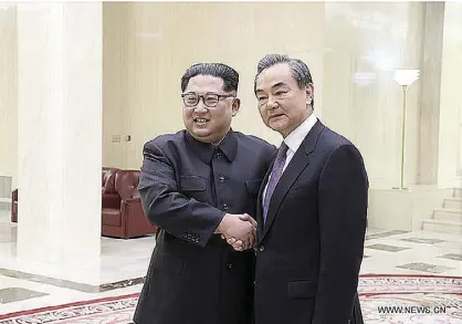  ?? XINHUA ?? Democratic People’s Republic of Korea (DPRK) Top Leader Kim Jong Un shakes hands with Chinese State Councilor and Foreign Minister Wang Yi in Pyongyang, the DPRK, May 3, 2018.