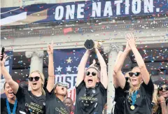  ??  ?? SERIAL CHAMPS: The US women’s team celebrate their World Cup victory last year.