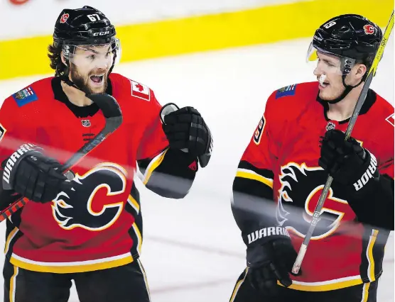  ?? JEFF MCINTOSH/THE CANADIAN PRESS ?? Michael Frolik, left, and Matthew Tkachuk are pieces of the ever-changing puzzle that Flames coach Bill Peters manipulate­s if the situation warrants it.