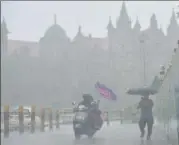  ?? PTI ?? Commuters move through heavy rain at Fort area, in Mumbai on Saturday.