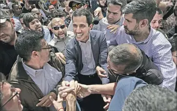  ?? Fernando Llano Associated Press ?? JUAN GUAIDO, Venezuela’s self-declared interim president, greets supporters in Caracas. President Trump’s decision to recognize his legitimacy seemed abrupt, but it came after careful multilater­al action.