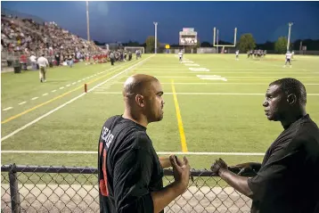  ?? The Washington Post by Andy Jacobsohn ?? ■ Democratic congressio­nal candidate Colin Allred, left, with former coach Von Harris at a Hillcrest High football game.