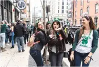  ?? TYLER LARIVIERE/SUN-TIMES ?? Pre-St. Patrick’s Day revelry takes place in River North over the weekend. Given the coronaviru­s outbreak, the actual holiday should be best celebrated indoors, the SunTimes Editorial Board writes.