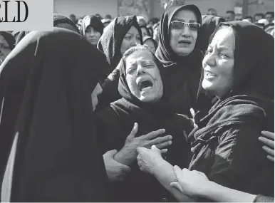  ?? EBRAHIM NOROOZI / THE ASSOCIATED PRESS ?? Families mourn the victims of Saturday’s terror attack on a military parade in the southwest Iranian city of Ahvaz, which killed 25 people, at a mass funeral ceremony on Monday.
