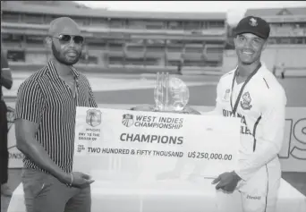  ?? ?? Harpy Eagles captain Tevin Imlach (right) receives the winner’s cheque from CWI President Dr. Kishore Shallow.