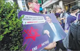  ?? Kathy Willens The Associated Press ?? A man joins protesters Thursday outside the offices of New York Gov. Andrew Cuomo. Three Rockland County Jewish congregati­ons are suing Cuomo and New York state.