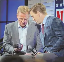  ?? STAFF PHOTO BY NANCY LANE ?? IS THIS THING ON? NFL commission­er Roger Goodell checks his microphone with Giants quarterbac­k Eli Manning before yesterday’s fan forum in Houston.