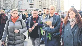  ?? — AFP photos ?? Yulia Navalnaya (second right), widow of the late Kremlin opposition leader Alexei Navalny, arrives for a rally near the Russian embassy in Berlin, where voters lined up to cast their ballots in the Russia’s presidenti­al election.