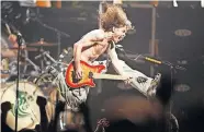  ?? MUNSON/NJ ADVANCE MEDIA VIA THE ASSOCIATED PRESS] ?? In this June 22, 2004, photo, Eddie Van Halen plays the final chord of “Jump” during the Van Halen concert at the Continenta­l Airlines Arena in East Rutherford, N,.J. [JOHN