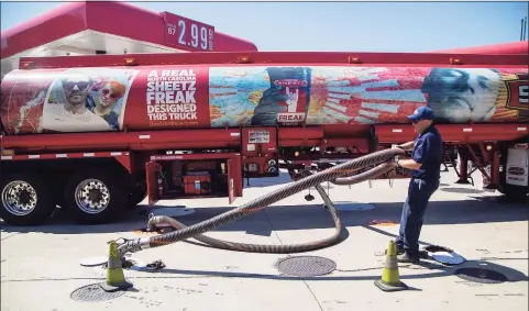  ?? Associated Press ?? A fuel tanker driver delivers a 9,000 gallon load of fuel at the Sheetz in Raleigh, N.C., on Thursday. Operators of the Colonial Pipeline say they began the process of moving fuel through the pipeline again on Wednesday, six days after it was shut down because of a cyberattac­k.