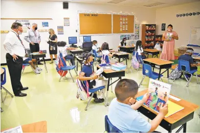  ?? PAUL W. GILLESPIE/CAPITAL GAZETTE PHOTOS ?? Van Bokkelen Elementary School Principal Kellie Schell-Ramey, in black dress, gives AACPS Superinten­dent George Arlotto, center, and board of education member Robert Silkworth, left, a tour of a third grade classroom Wednesday.