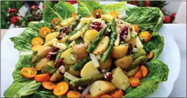  ?? ?? A salad of asparagus and potatoes with kumquats is served on a bed of romaine.