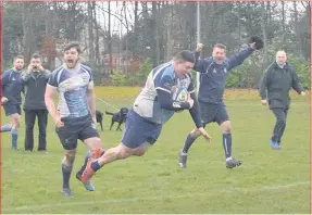  ??  ?? Celebratio­n Euan Constable dives over the line for a try