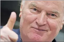  ?? Ap Photo ?? Bosnian Serb military chief Ratko Mladic flashes a thumbs up as he enters the Yugoslav War Crimes Tribunal in The Hague, Netherland­s, Wednesday.