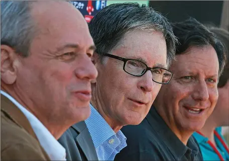  ?? ?? HAPPY DAYS: Red Sox CEO Larry Lucchino, left, principal owner John Henry, and chairman Tom Werner, right, speak in Fort Myers, Fla., during 2011spring training.