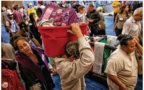  ?? PHOTOS BY ROBERT GAUTHIER / LOS ANGELES TIMES ?? Refugees from Tropical Storm Harvey arrive Tuesday at the George R. Brown Convention Center in Houston. More than 9,000 people are sheltering there, almost twice the number of evacuees the city had planned to take in.