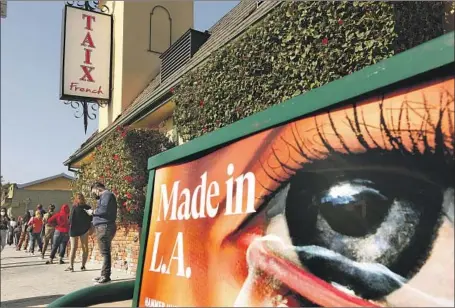  ?? Genaro Molina Los Angeles Times ?? PEOPLE WAIT I N LINE for free coronaviru­s testing in front of a closed Taix French Restaurant in L. A.’ s Echo Park neighborho­od.