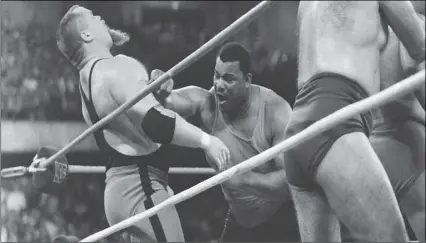  ?? AP PHOTO/CHARLIE BENNETT ?? This April 7, 1986, file photo shows Chicago Bears’ William Perry (right) landing a punch on pro wrestler Jim “The Anvil” Neidhart during the “Over-The-Top-Rope” battle royal at Wrestleman­ia 2 in Rosemont, Ill.