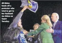  ??  ?? Jill Biden fends off a protester who tried to get to her husband Joe Biden on Super Tuesday.