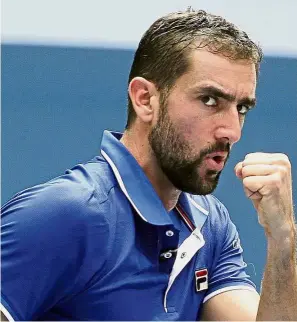  ?? — AP ?? Way to go: Marin Cilic of Croatia reacting after scoring a point against Tennys Sandgren of the United States during the first round on Monday.