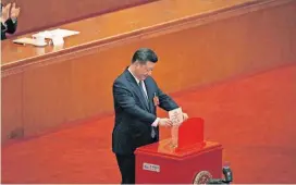  ?? [AP PHOTO] ?? Chinese President Xi Jinping casts his vote for an amendment to China’s constituti­on that will abolish term limits on the presidency and enable him to rule indefinite­ly, during a plenary session of the National People’s Congress on Sunday at the Great...