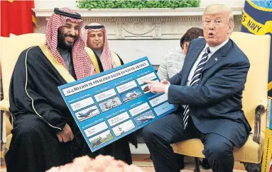  ?? EVAN VUCCI/THE ASSOCIATED PRESS FILE PHOTO ?? U.S. President Donald Trump shows a chart highlighti­ng arms sales to Saudi Arabia during a meeting with Saudi Crown Prince Mohammed Bin Salman in the Oval Office of the White House in March.