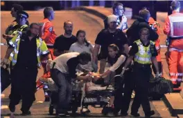  ?? — AFP ?? The police and members of the emergency services attend to victims of the terror attack at London Bridge on Saturday night.