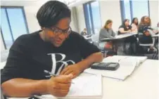  ?? Helen H. Richardson, The Denver Post ?? White, 28, works on solving math problems during her math class at the Community College of Denver.