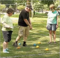  ?? CHRIS BARBER — DIGITAL FIRST MEDIA ?? Judges measure the ball distances in the bocce competitio­n.