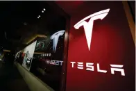  ?? The Associated Press ?? ■ A sign bearing the Tesla company logo is displayed outside a Tesla store on Feb. 9, 2019, in Denver. Mexico is undergoing competitio­n among several states to attract a possible Tesla facility.