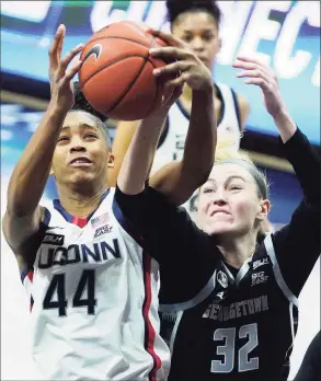  ?? David Butler II / Associated Press ?? UConn’s Aubrey Griffin (44) tries to steal the ball from Georgetown’s Taylor Baur (32) during a January game in Storrs.