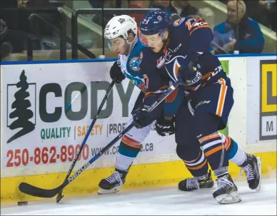  ?? CINDY ROGERS/www.nyasa.ca ?? Dillon Dube of the Kelowna Rockets, left, battles for the puck against Nolan Kneen of the Kamloops Blazers in WHL action Friday at Prospera Place in Kelowna.The Blazers posted a 3-2 victory.