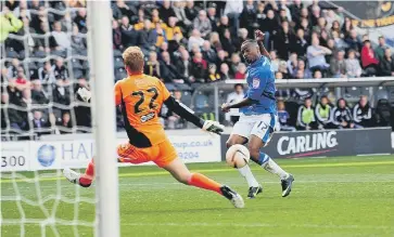  ?? ?? Emile Sinclair scores the second goal of his hat-trick for Posh at Hull in September 2012.
