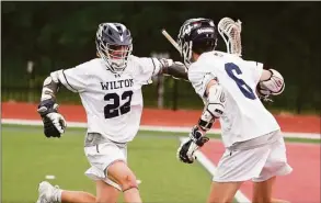  ?? Dave Stewart / Hearst Connecticu­t Media ?? Wilton’s Michael Wall (22) and Thomas McKiernan celebrate a goal during their win over Notre Dame-West Haven in the Class M championsh­ip game Sunday.