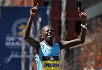  ?? ?? FASTEST WOMAN: Women's winner Peres Jepchirchi­r crosses the finish line.