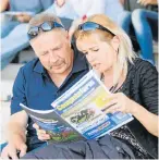  ?? Picture: FREDLIN ADRIAAN ?? CLUED UP: Marianne and Chris Schoeman from Seaview check out the horses’ form at the Algoa Cup Race at the Fairview Racecourse last weekend