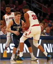  ?? ADAM HUNGER — THE ASSOCIATED PRESS ?? St. John’s guard LJ Figueroa (30) steals the ball from Villanova guard Collin Gillespie (2) during the second half of an NCAA college basketball game Sunday in New York.