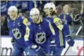  ?? CHRIS O’MEARA — THE ASSOCIATED PRESS ?? Atlantic Division’s Nikita Kucherov, center, of the Tampa Bay Lightning, smiles as he is congratula­ted by Steven Stamkos, left, of the Lightning, and Erik Karlsson, right, of the Senators, after scoring a hat trick during the NHL All-Star game against...