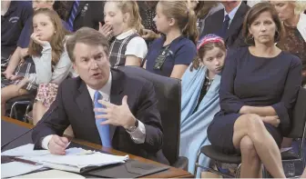  ?? AP Photo ?? FAMILY GUY: Judge Brett Kavanaugh testifies in Washington as his wife, Ashley Estes Kavanaugh, and their daughters look on.