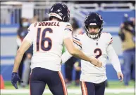  ?? Leon Halip / Getty Images ?? The Bears’ Pat O’Donnell, left, and Cairo Santos react after Santos’ winning field goal against the Lions during the fourth quarter on Thursday.