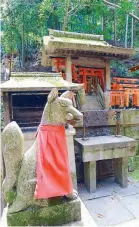  ??  ?? A carved inari stone fox guarding an altar at the Fushimi Inari shrine