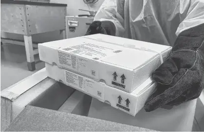  ?? CONTRIBUTE­D ?? Two trays of Pfizer/BioNTech vaccine doses are unloaded before being stored in an ultra deep freezer at the Health Sciences Centre in St. John’s, N.L.