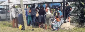  ?? ADRIAN FRATER PHOTO ?? Relatives of detainees under the state of emergency at the fence at the Freeport Police Station in St James.