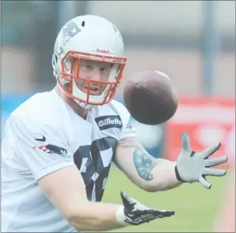  ?? CHARLES KRUPA/AP PHOTO ?? Patriots tight end Jake Ballard catches a pass during practice Friday at Foxborough, Mass.