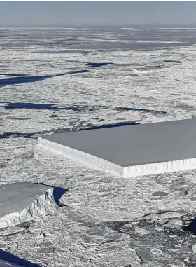  ?? NASA via AFP / Getty Images ?? This NASA image from an Operation IceBridge flight over Antarctica shows a tabular iceberg floating among sea ice just off of the Larsen C ice shelf.